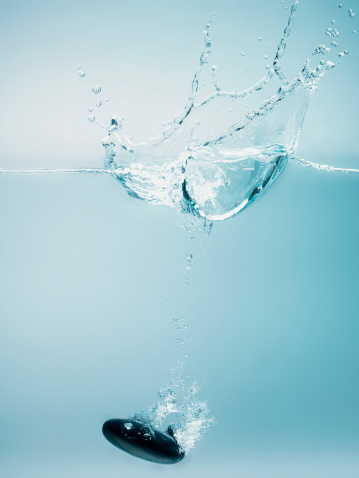 stone sinking in water
